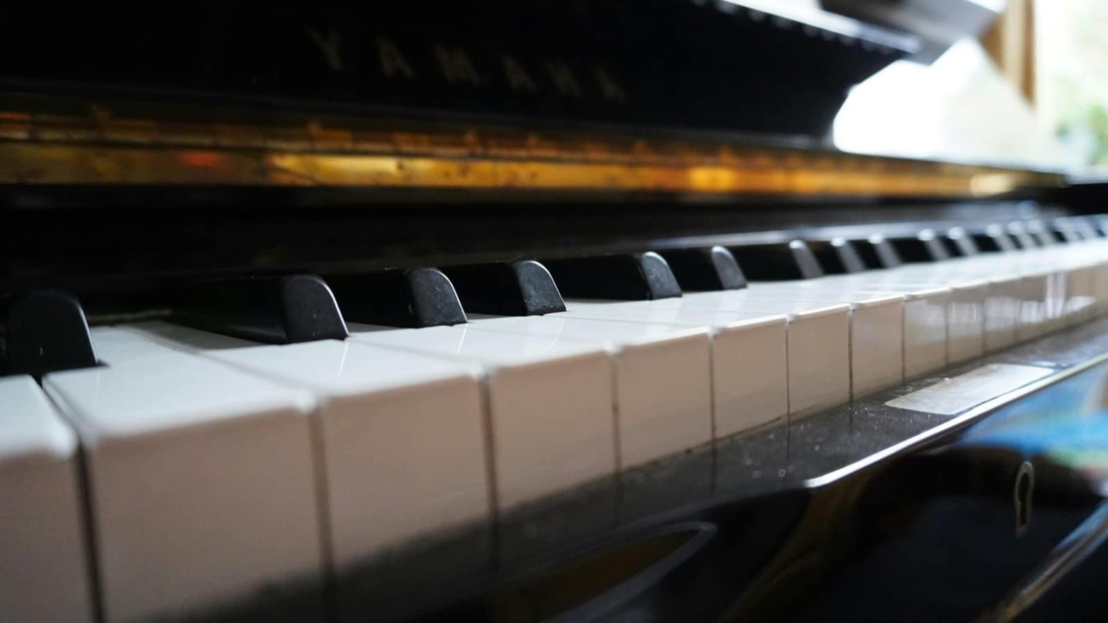 a close up of a piano with a black and white keyboard