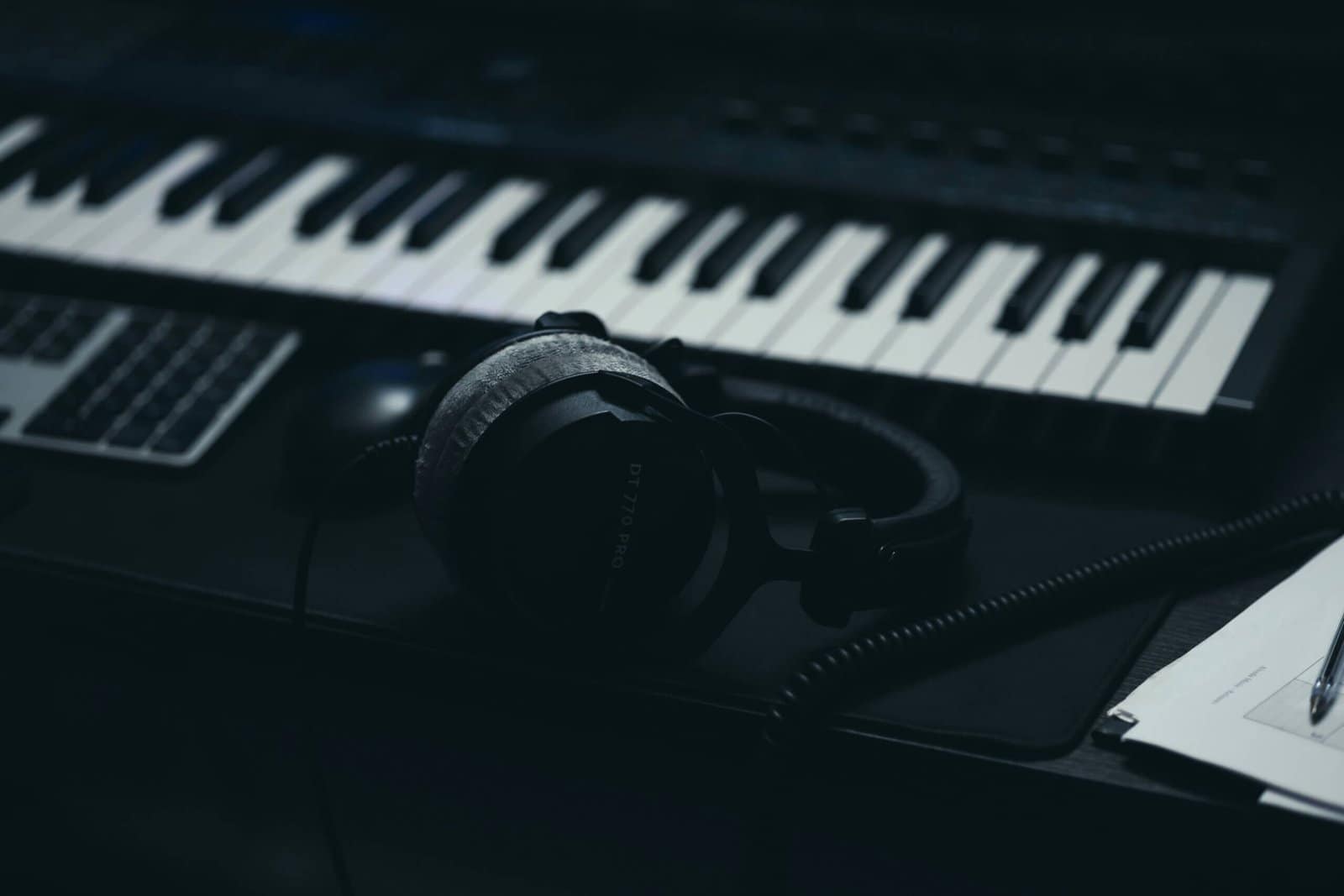 A keyboard with headphones and a microphone